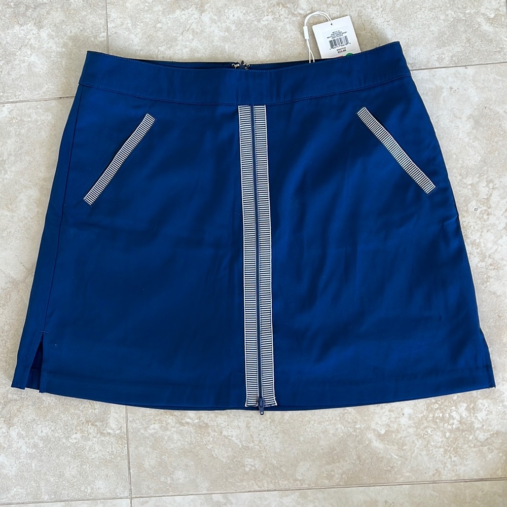 Navy golf skort, with classic detail. Super cute. NEVER WORN with tags. Size 8.
